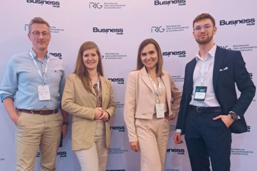 Group of four business professionals posing in front of Health Business Innovation 2025 backdrop at the Regional Chamber of Commerce in Katowice