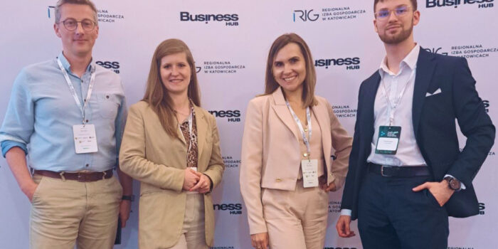 Group of four business professionals posing in front of Health Business Innovation 2025 backdrop at the Regional Chamber of Commerce in Katowice